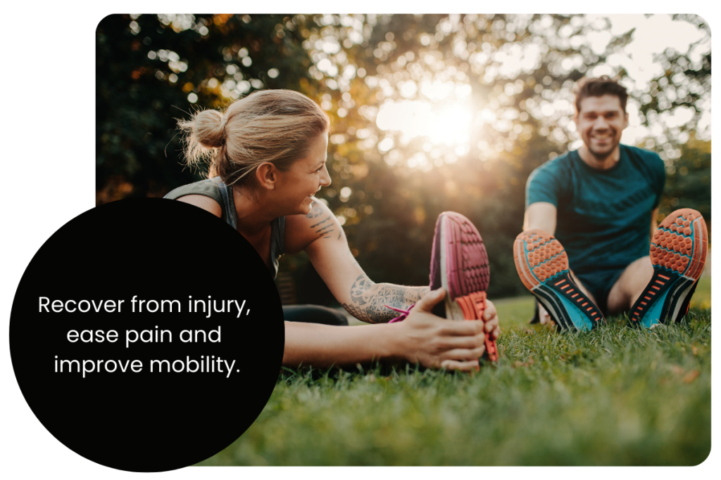 Two people stretch and smile on sunny grass in Brooklyn, Melbourne’s west. Text promotes injury massage at Glenn Kinder Massage.